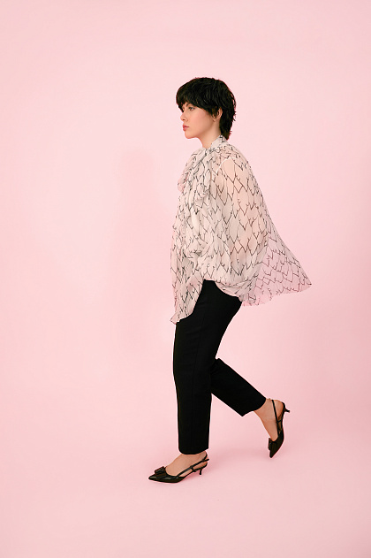 A white chiffon blouse with an author's print